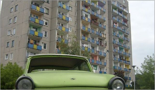 Green Trabant on a parking lot next to an apartament building in Zielona Góra 65-021 - Zdjęcia
